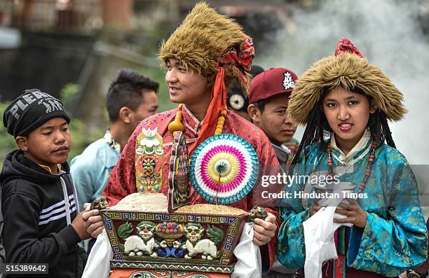 Tibetan exile girls dressed up in traditional dress reach before the arrival of Tibetan spiritual leader Dalai Lama at Dharamsala, as he arrived from...