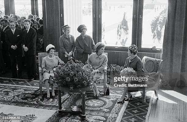 Mrs. Jacqueline Kennedy talks to Madame De Gaulle after her arrival here with President Kennedy, May 31st. Others in the party are Mrs. Joseph P....