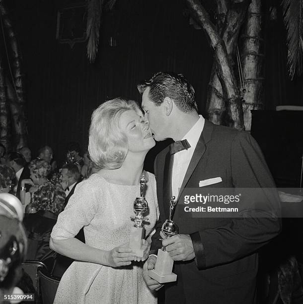 Actor Rock Hudson bosses Actress Doris Day as they hold their Golden Globe Awards presented to them by the membered of the Hollywood Foreign Press...