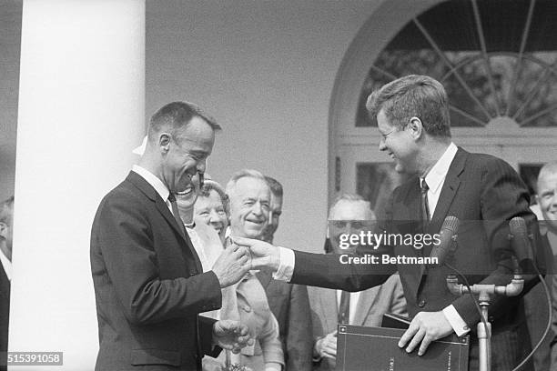 During a ceremony at the White House, President Kennedy presents Alan B. Shepard Jr. With the Distinguished Service Medal for becoming the first...