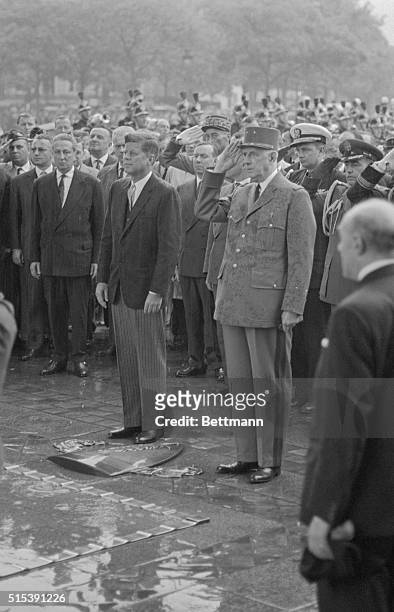President John F. Kennedy stands next to French President Charles De Gaulle during a memorial ceremony at the Tomb of the Unknown Soldier.
