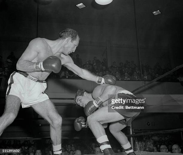 Lulu Perez of Brooklyn ducks under the long left of Paolo Rosi, Italian lightweight, in the third round of their bout at St. Nick's Arena tonight....