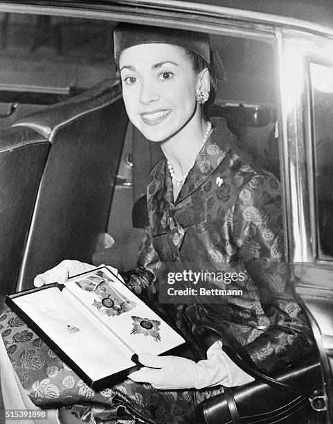 World famous ballerina Margot Fonteyn proudly displays the Medal of the Order of the British Empire in which she was invested at Buckingham Palace...