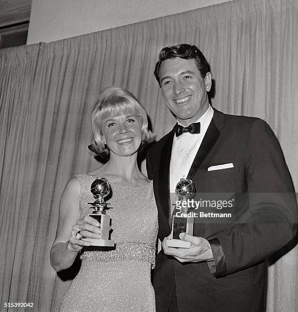 Honored as the "World Film favorites by the Hollywood Foreign press Association, Doris Day and Rock Hudson hold their Golden Globes as they pose for...