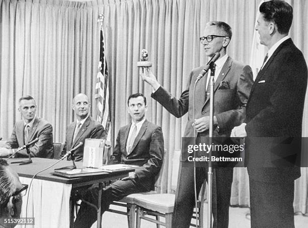 Sacramento, California: Apollo 10 astronauts Eugene Cernan, Tom Stafford, and John Young listen as Charles Shultz, creator of the comic strip...