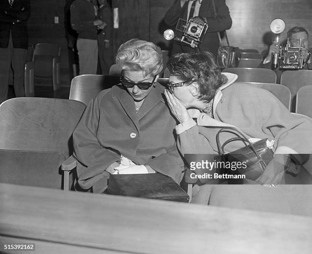 Mother Consoles Lana at Hearing. Los Angeles, California: Mrs. Mildred Turner, right, leans over to comfort her daughter, actress Lana Turner, who...