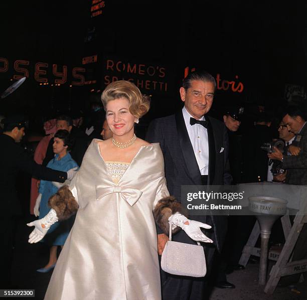 New York, New York: Arriving for premier of Cleopatra, at the Rivoli Theater are Joan Fontaine and Charles Addams.