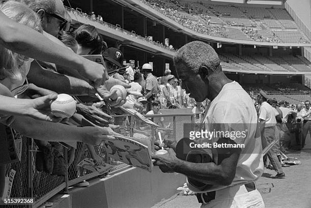 Former Dodger great Jackie Robinson signs autographs before the start of the "Old timers" game between the Angels-Dodgers at Anaheim Stadium....