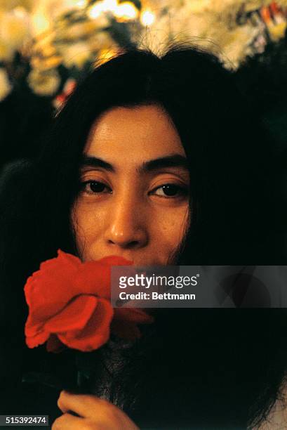 Head shot of musician and artist Yoko Ono, with a rose during her "Bed-in for Peace" demonstration