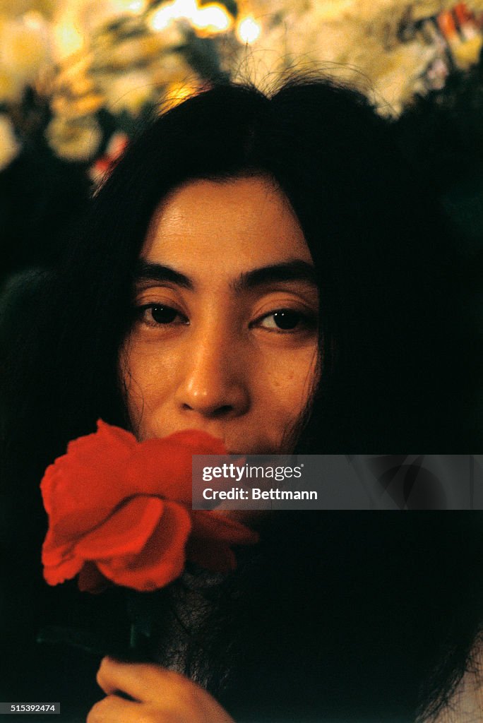 Head shot of musician and artist Yoko Ono, with a rose during her ...