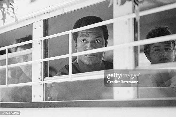 Former football star Jim Brown looks none too happy as he sits in a sheriff's bus on arrival at Beverly Hills municipal Court. Brown was arrested...