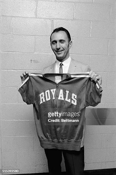 Basketball coach Bob Cousy, returning as a player after a six-year absence, displays a new uniform here November 18 after the Cincinnati Royals and...