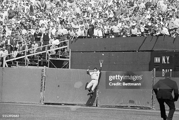 World Series- Mets rightfielder Ron Swoboda leaps in vain for Don Buford's line drive which cleared the fence for a home run in the first inning of...
