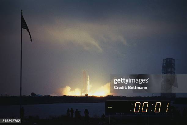 Apollo 12 ingition and blast-off as viewed from a distance. The countdown clock in the foreground measures the seconds until blast time. Apollo 12...