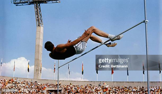 American high jumper Dick Fosbury clears the bar on his third attempt at the 1968 Summer Games in Mexico City. Fosbury won the gold medal with this...