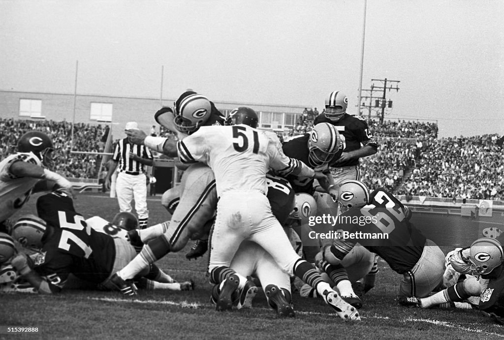 Green Bay Packer Player Being Stopped by Opponents
