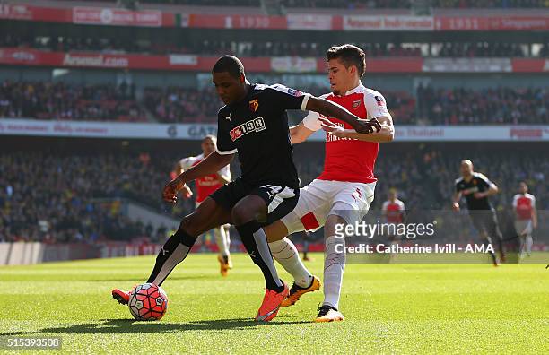 Odion Ighalo of Watford and Gabriel Paulista of Arsenal during the Emirates FA Cup match between Arsenal and Watford at the Emirates Stadium on March...
