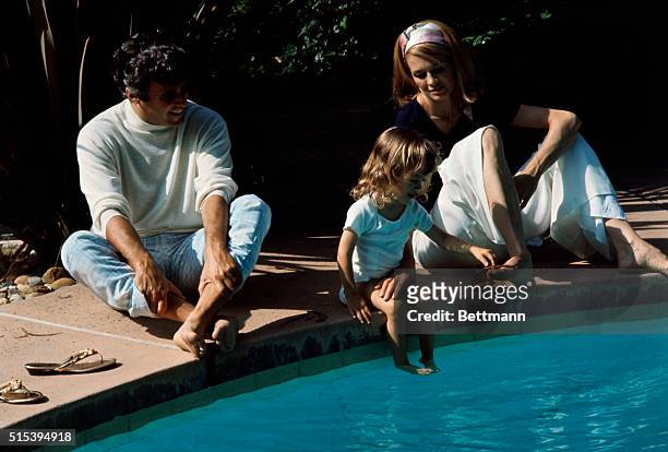 Miscellaneous color shot of composer Burt Bacharach, wife Angie Dickinson, and daughter Lea Nikki on the grounds and around the swimming pool of...