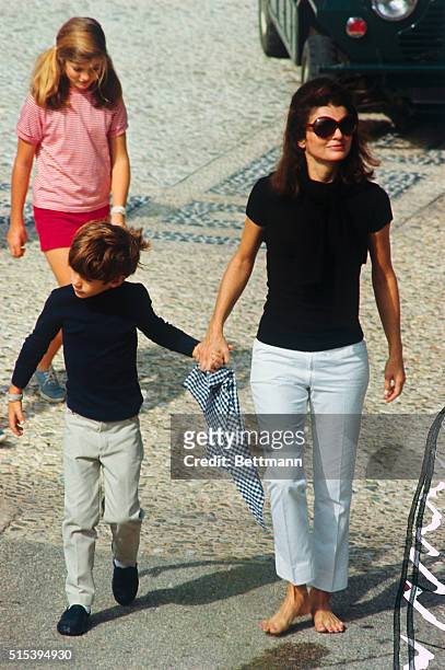 Jacqueline Kennedy, widow of president John F. Kennedy, walks with their children John Jr. And Caroline on the day before her wedding to Aristotle...