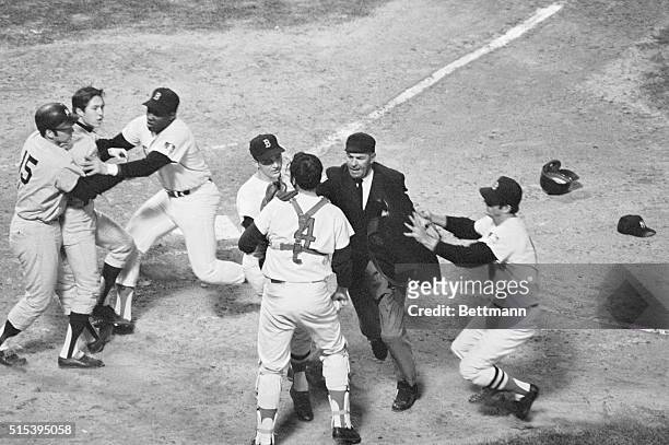 The New York Yankees' Thurman Munson and the Boston Red Sock's George Scott hold back Yanks' Bobby Murcer as Red Sox pitcher Ken Brett , plate umpire...