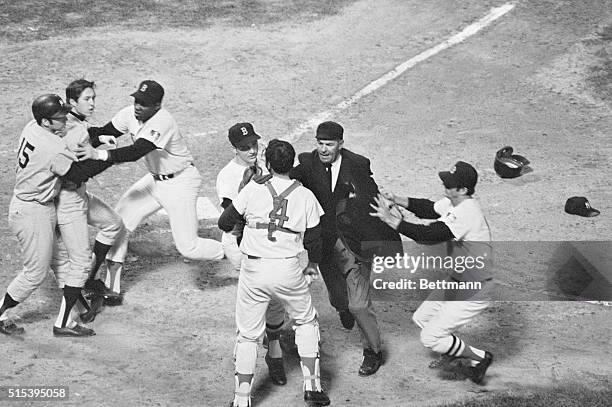 The New York Yankees' Thurman Munson and the Boston Red Sock's George Scott hold back Yanks' Bobby Murcer as Red Sox pitcher Ken Brett , plate umpire...