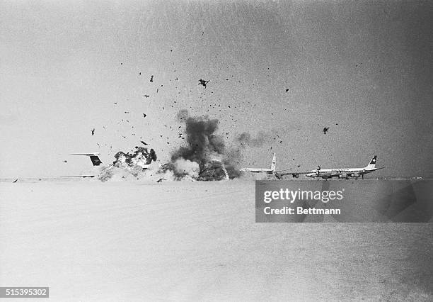 Shrapnel, smoke and desert dust erupt on this desolate airstrip as one of three BOAC VC-10 jetliners hijacked by Arab guerrillas blows up. All three...