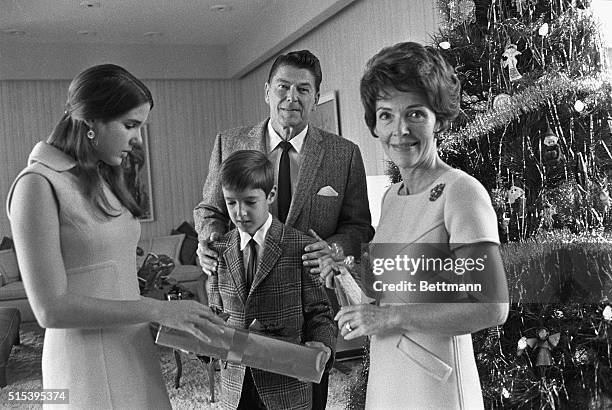 California Governor Ronald Reagan and his wife, Nancy , gather around the Christmas tree with children Patti, and Ron, Jr., December 1970.