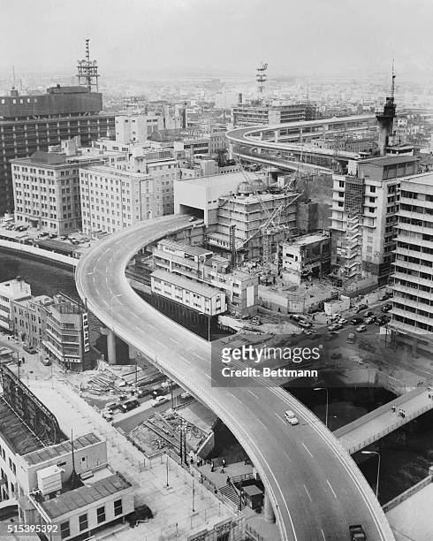 Express highways curve and cross over the Yashjigawa River in downtown Osaka, where an increasing number of modern and ever-higher office buildings...