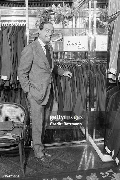 President of Barney's New York Fred Pressman standing next to blazers in a Barney's store.