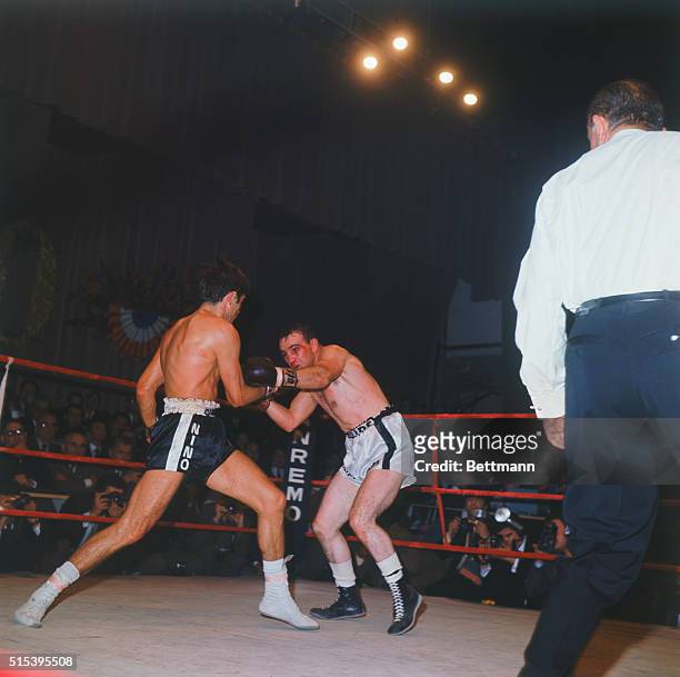 Rome, Italy: Italian middleweight boxing champ Nino Benvenuti an American challenger Don Fullmer start to mix it up during the first round of their...