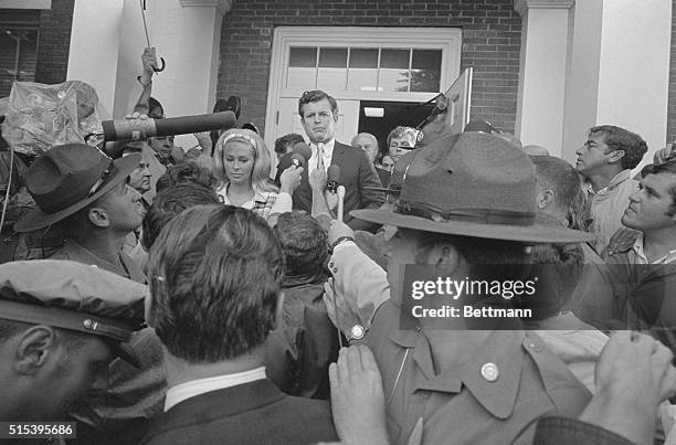 Edgartown, Mass.: Lady with a camera gets close-up view as Sen. Edward M. Kennedy escorts wife, Joan through crowd of newsmen to Dukes County Court...