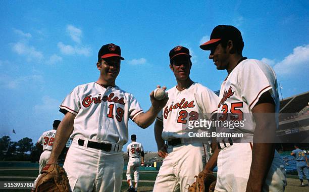 Pitching aces Mike Cuellar , Jim Palmer , and Dave McNally of the Baltimore Orioles baseball team, in uniform in a baseball stadium.