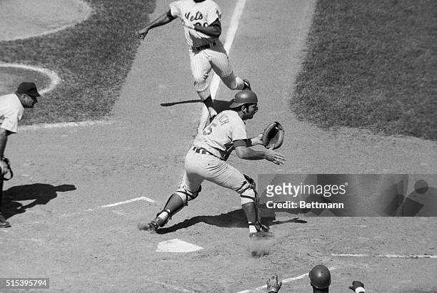 New York Mets' Tommie Agee slips a foot between Cincinnati Reds' catcher Johnny Bench's legs but is out anyway trying to score on Ron Swoboda's fly...