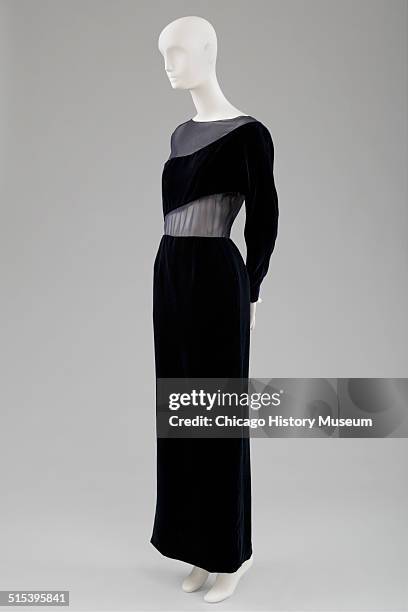 Evening gown, designed by Carolyne Roehm, of navy blue velvet with chiffon covered cutouts, 1991. Shown as part of the Chicago History Muesum's...