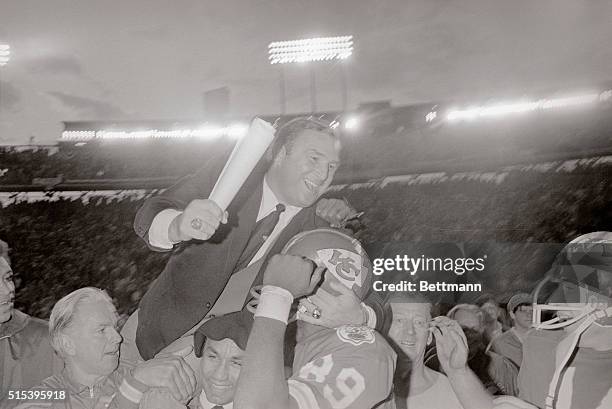 Hank Stram, head coach of the Superbowl champions Kansas City Chiefs, grabs wide receiver Otis Taylor around the head as he is carried off the field...