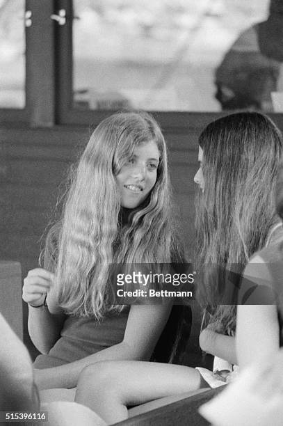 Daughter of the late President John F. Kennedy, Caroline Kennedy chats with an unidentified friend during the fourth round action of the U.S. Open...