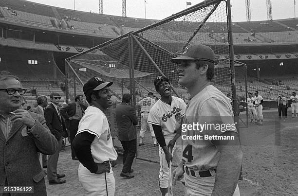 Baltimore Orioles Don Buford and Paul Blair kid around with Cincinnati Reds' Pete Rose during warm up before third game of the World Series.