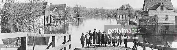 In Manitoba, Canada Live in Attics Following Floods. Occupants of half the houses in Brandon, Manitoba, Canada with a population of about 50,000 are...