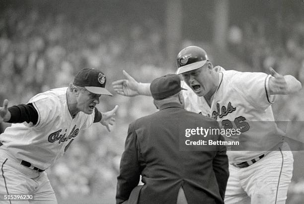 First base umpire Emmett Ashford gets an earful from Orioles skipper Earl Weaver and base runner Boog Powell during Game 5 of the 1970 World Series...