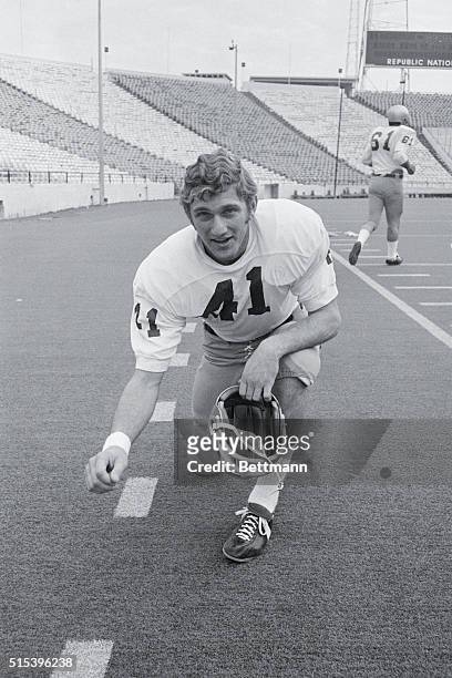 Dallas: Notre Dame quarterback Joe Theismann is all smiles as he checks the astroturf in the Cotton Bowl December 28th as Notre Dame works out for...