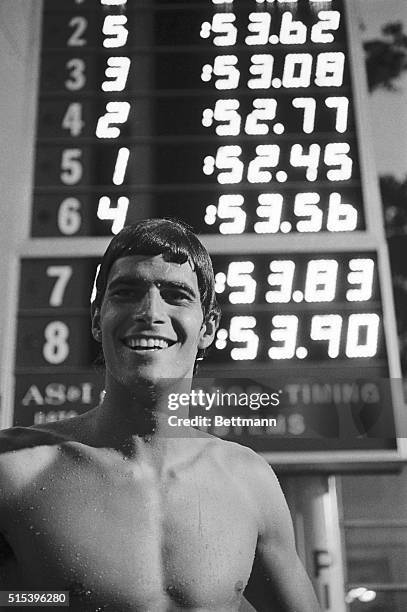 Mark Spitz wears a proud smile 8/27 as he stands in front of a board which shows his winning time of 52.45 seconds for the men's 100-meter freestyle....