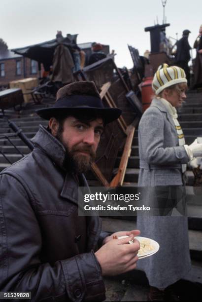 English actor Alan Bates on the set of Ken Russell's 'Women in Love', adapted from the novel by D H Lawrence, November 1968. Behind him is his...