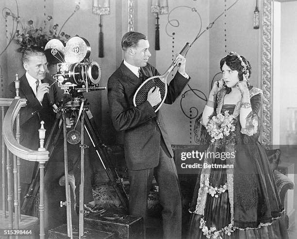 "Emoting" to the strains of music from a tennis racquet. Ever try it? Well-take the word of Bebe Daniels, Paramount star, that it isn't what its...