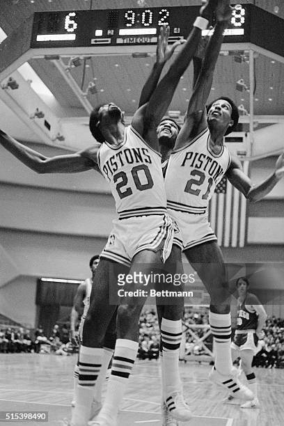 Pistons Otto Moore, and Dave Bing, team up to squeeze out Rocket Stu Lantz, , as all went up for a rebound off the Detroit basket during the...