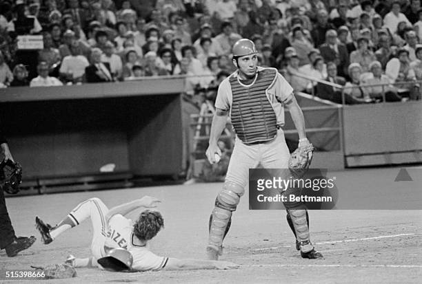 St. Louis Cardinals' Ted Sizemore is forced out at home plate and locks feet with Cincinnati Reds' catcher Johnny Bench in the sixth inning of...