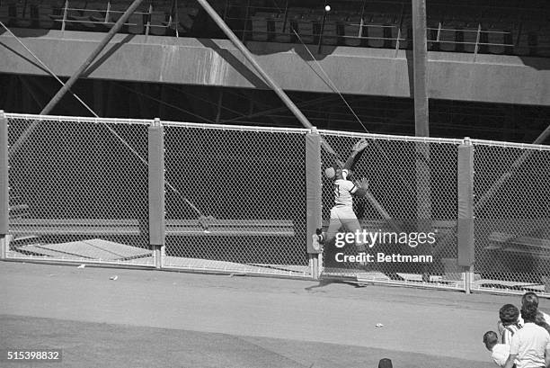 San Francisco, CA- Pittsburgh Pirates outfielder, Roberto Clemente, jumps in the air, but not high enough, as he goes for San Francisco Giants', Tito...