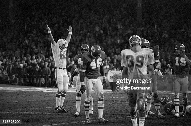 Photo was made moments after Garo Yepremian's game winning field goal cleared the bar. Yepremian's holder, Karl Noonan signals "it's good" and...