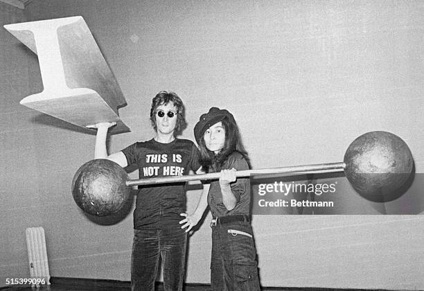 Yoko Ono, right, with assistance from her husband, former Beatle John Lennon, put the finishing touches to her first one-man show in the Everson Art...