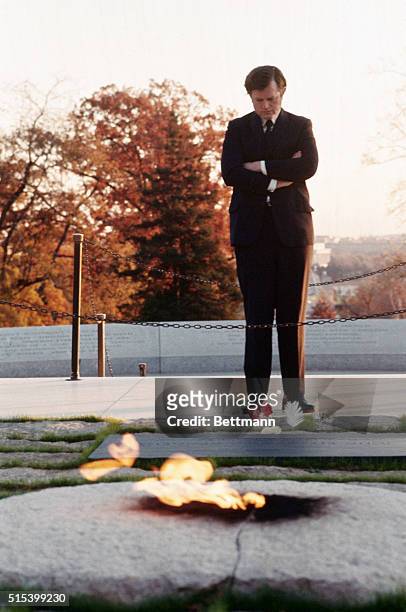 Senator Edward Kennedy , stands at the grave of the late President John F. Kennedy in an early morning tribute 11/22. Senator Kennedy came alone to...