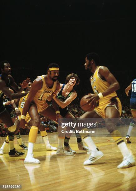 Wilt Chamberlain of the Los Angeles Lakers blocks Pete Maravich of Atlanta Hawks while Jim McMillan attempts to shoot during the game here. The...